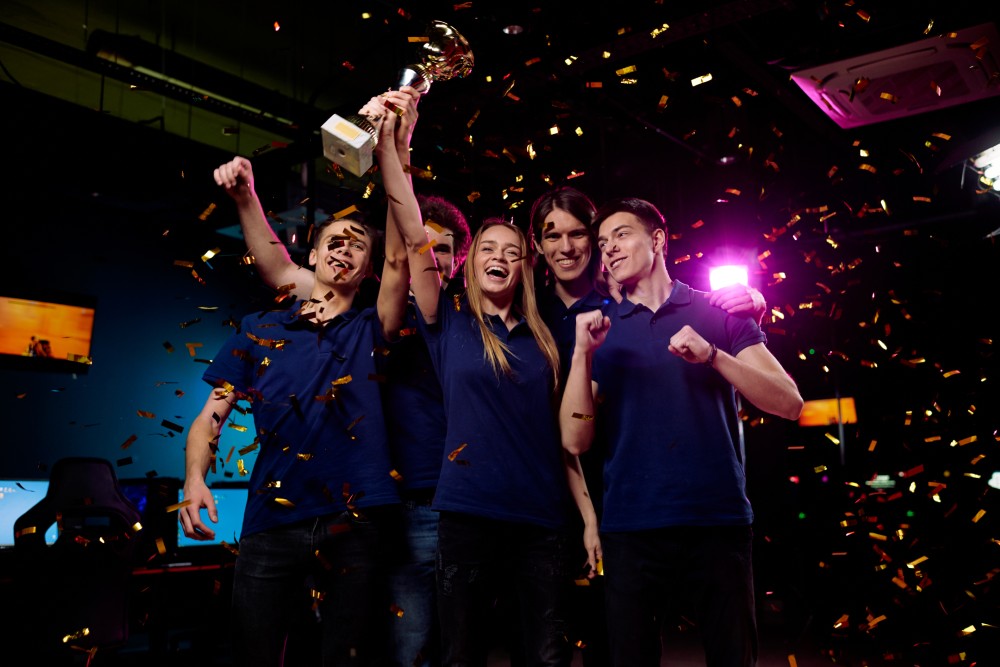 Five ecstatic young friendly video gamers expressing pride of their winning